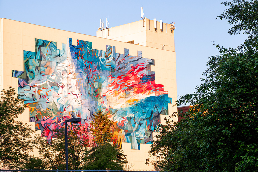 Brightly coloured graffiti on the side of a building.