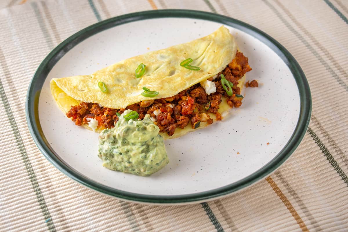 Omelette with ground chorizo inside. Guacamole on the side.