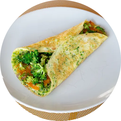White plate with a rolled omelette filled with broccoli and cheese.
