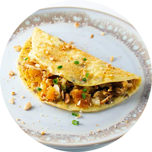 Omelette on a white plate with brown trim.