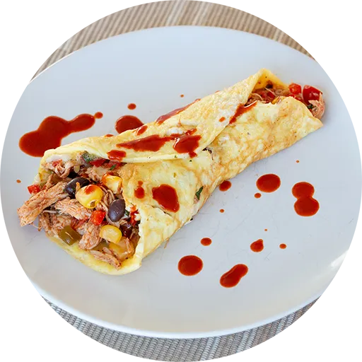 White plate with a rolled omelette filled with chicken, peppers, beans, corn and salsa.