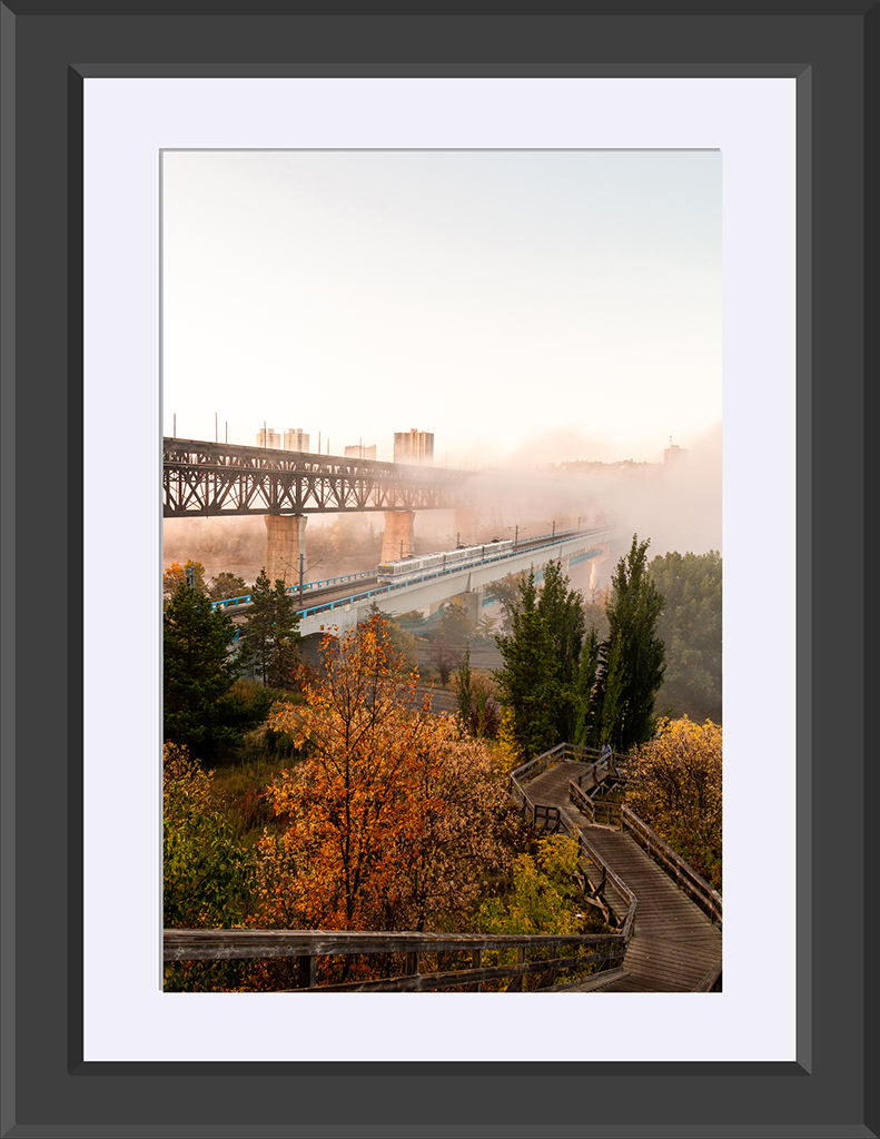 Foggy sunrise with two bridges over a river valley with autumn colours.