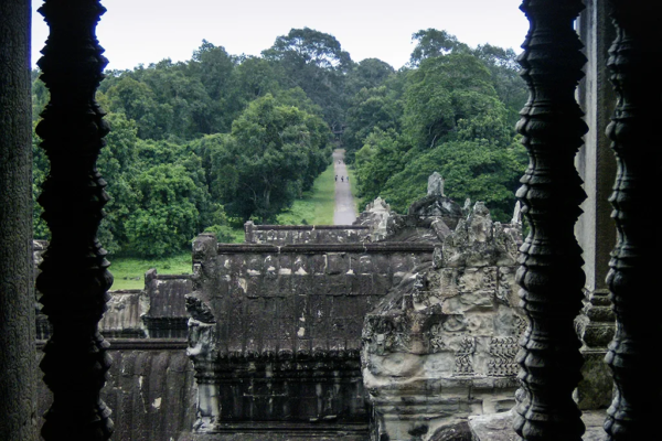 Looking down at a path in the jungle from ancient stone ruins.