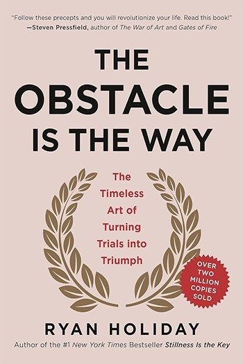 Pink book cover with the title - The Obstacle is the Way