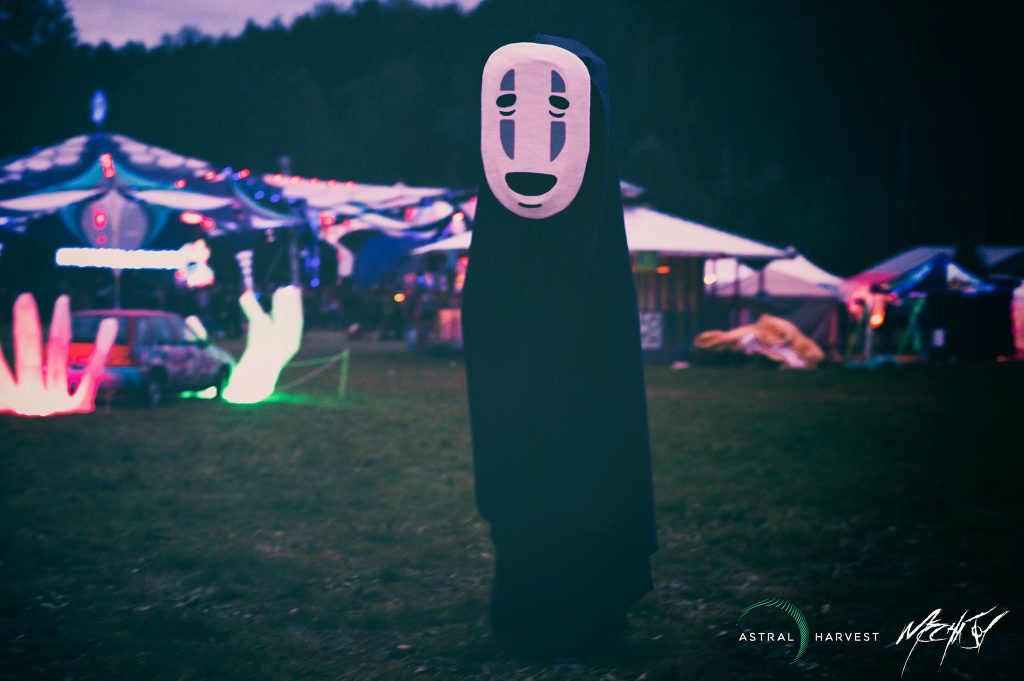 Person wearing a costume of "No Face" from the movie Spirited Away.